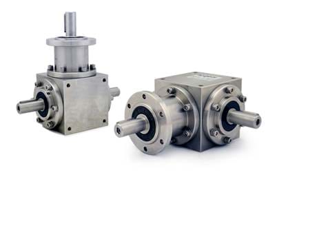 Two spiral bevel gearboxes of cast iron on a transparent background